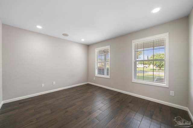 unfurnished room with dark hardwood / wood-style floors