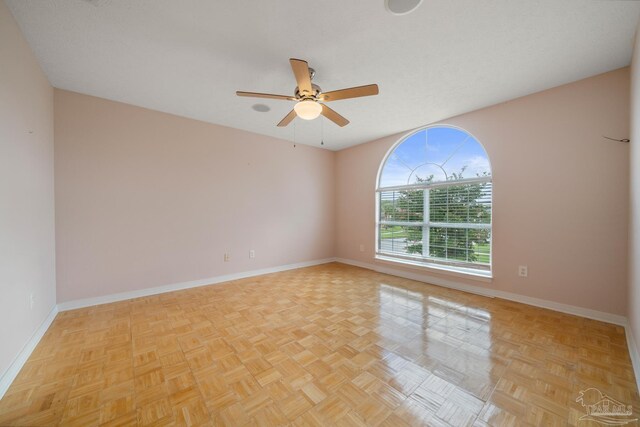 empty room with dark hardwood / wood-style flooring, an inviting chandelier, and a healthy amount of sunlight