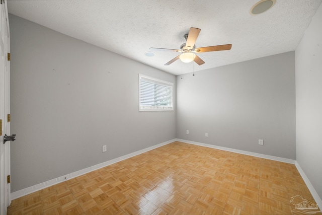 unfurnished room featuring light parquet floors, ceiling fan, and a textured ceiling