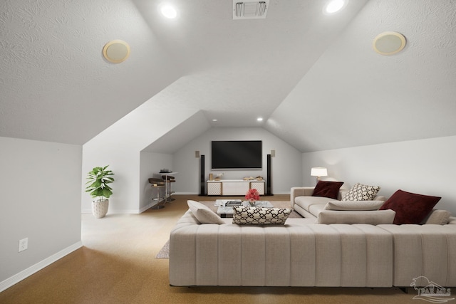 carpeted living room featuring vaulted ceiling and a textured ceiling