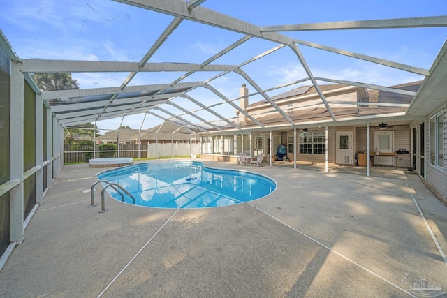 view of pool with a lanai, a patio, and ceiling fan