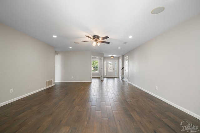 unfurnished living room with dark hardwood / wood-style floors and ceiling fan