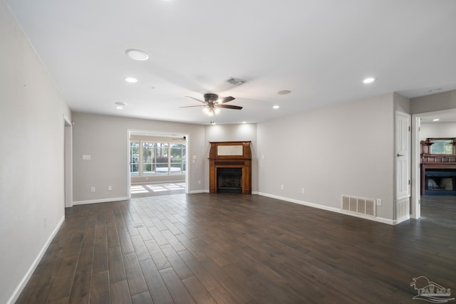 unfurnished living room with dark wood-type flooring and ceiling fan