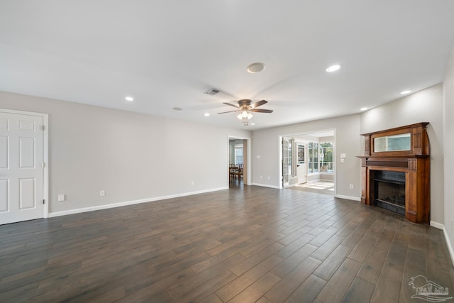 unfurnished living room with dark hardwood / wood-style floors and ceiling fan