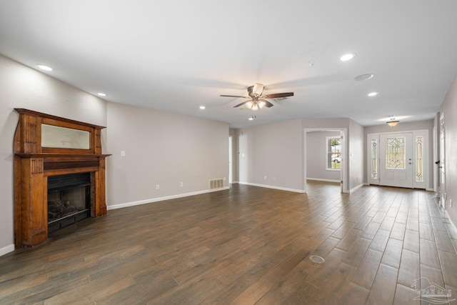 unfurnished living room with dark hardwood / wood-style floors and ceiling fan