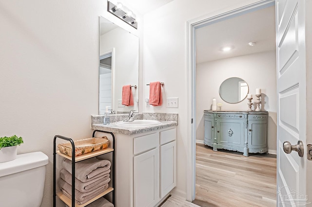 4366 White Cedar Ct, Pace, FL 32571 - bathroom featuring vanity, toilet, wood finished floors, and baseboards