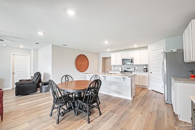 4366 White Cedar Ct, Pace, FL 32571 - dining area featuring light wood-type flooring and recessed lighting