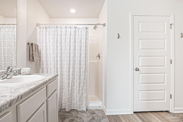 4366 White Cedar Ct, Pace, FL 32571 - bathroom with vanity, wood finished floors, a shower with shower curtain, and baseboards