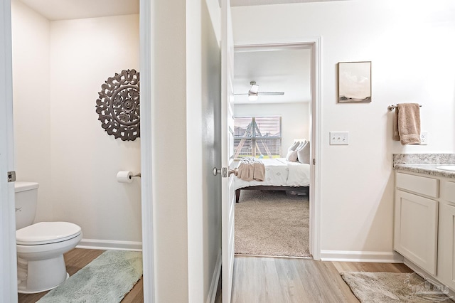 4366 White Cedar Ct, Pace, FL 32571 - bathroom featuring wood finished floors, toilet, vanity, ensuite bathroom, and baseboards