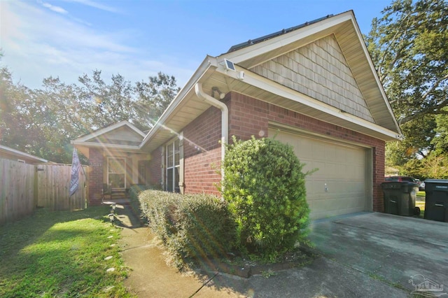 view of side of home featuring a lawn and a garage