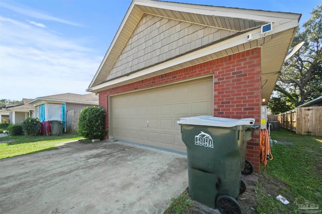 exterior space with central AC unit and a garage