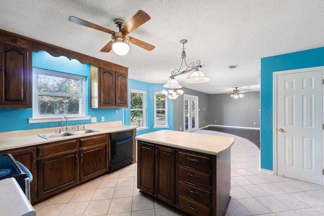 kitchen with a sink, dishwasher, a ceiling fan, and light countertops