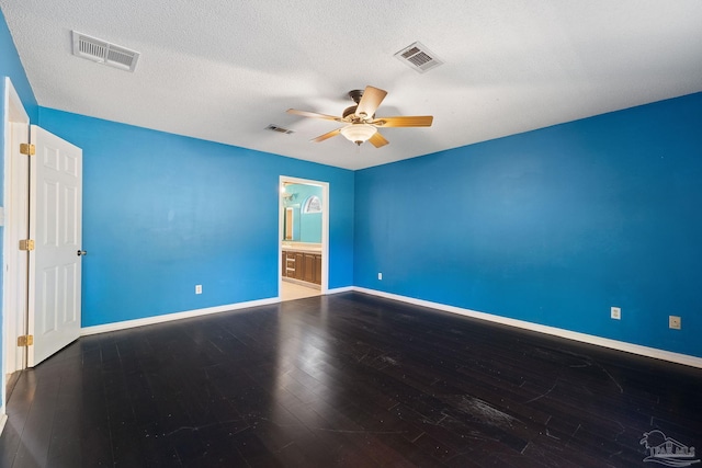 unfurnished room featuring visible vents, a ceiling fan, and hardwood / wood-style floors