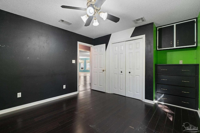 unfurnished bedroom featuring visible vents, baseboards, and wood finished floors