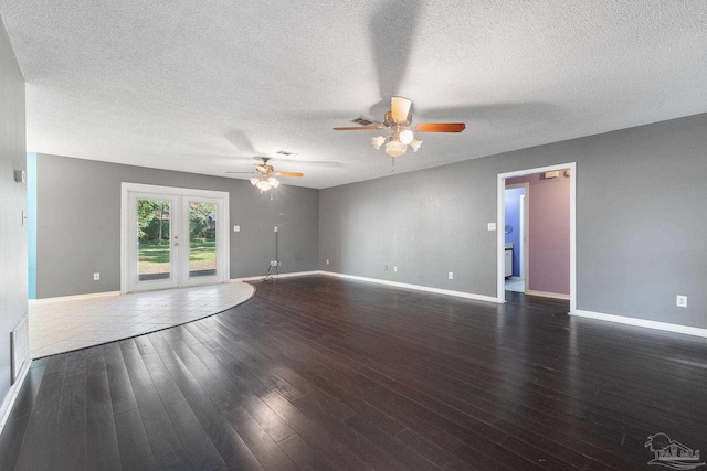 unfurnished room featuring baseboards, wood finished floors, visible vents, and ceiling fan