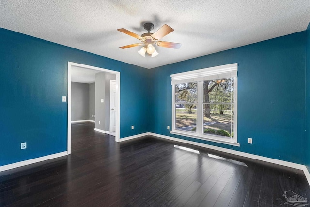 spare room featuring baseboards, a textured ceiling, wood finished floors, and a ceiling fan