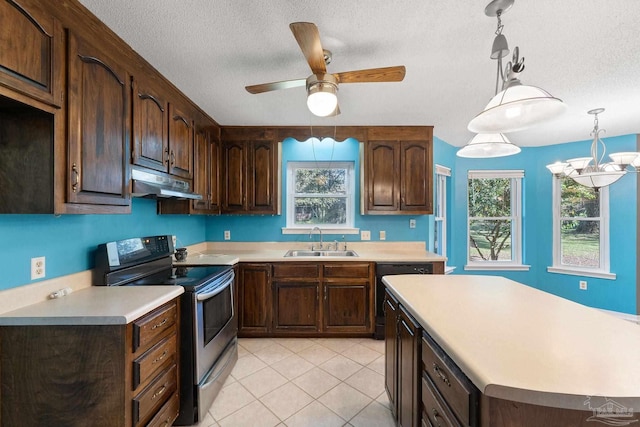 kitchen with under cabinet range hood, stainless steel electric range oven, light countertops, and a sink