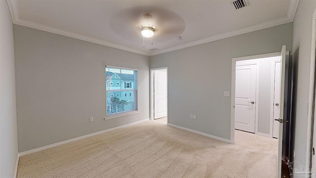 carpeted spare room featuring ceiling fan and ornamental molding