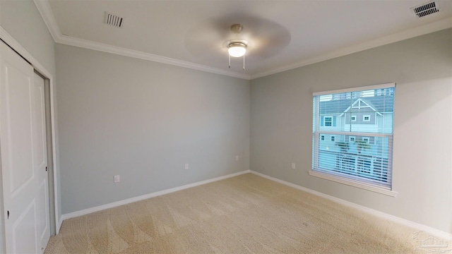 interior space with carpet, a closet, ceiling fan, and ornamental molding