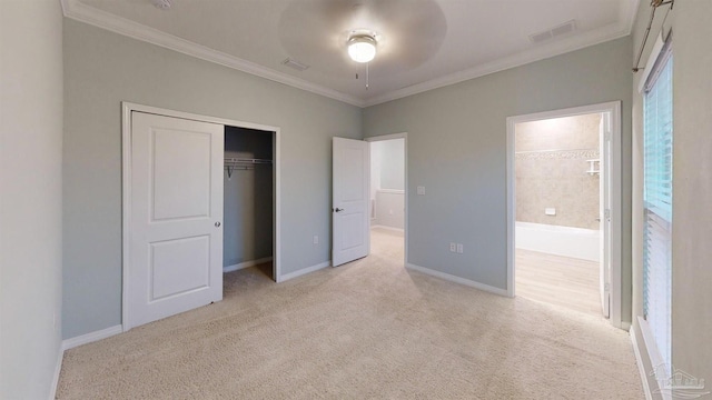 unfurnished bedroom featuring light carpet, a closet, and ornamental molding