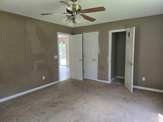 unfurnished bedroom featuring baseboards, a ceiling fan, and carpet flooring