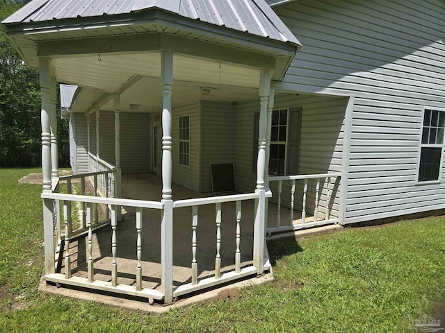 entrance to property with a yard and metal roof