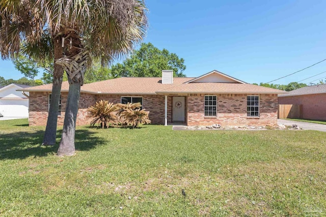 308 Twisted Oak Dr, Cantonment, FL 32533 - single story home with a chimney, a shingled roof, a front yard, and brick siding