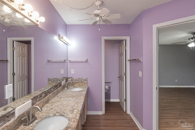 308 Twisted Oak Dr, Cantonment, FL 32533 - full bathroom featuring baseboards, a sink, wood finished floors, and ceiling fan