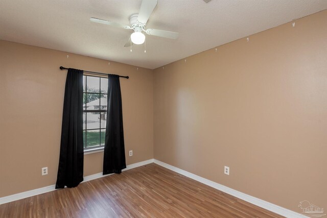 308 Twisted Oak Dr, Cantonment, FL 32533 - unfurnished room with wood finished floors, baseboards, and a ceiling fan