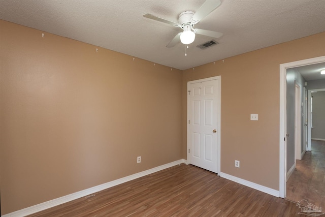 308 Twisted Oak Dr, Cantonment, FL 32533 - unfurnished bedroom with visible vents, baseboards, a ceiling fan, a textured ceiling, and wood finished floors