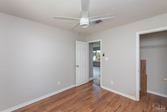 308 Twisted Oak Dr, Cantonment, FL 32533 - unfurnished bedroom with visible vents, baseboards, a closet, a textured ceiling, and wood finished floors