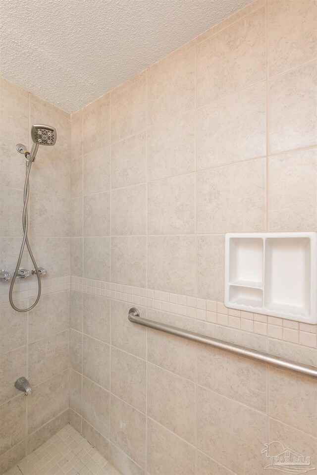 308 Twisted Oak Dr, Cantonment, FL 32533 - full bath featuring a textured ceiling and a tile shower