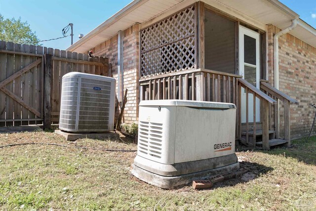 308 Twisted Oak Dr, Cantonment, FL 32533 - exterior details with a power unit, central AC unit, fence, and brick siding