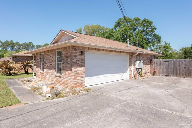 308 Twisted Oak Dr, Cantonment, FL 32533 - view of property exterior featuring brick siding, driveway, fence, and an attached garage
