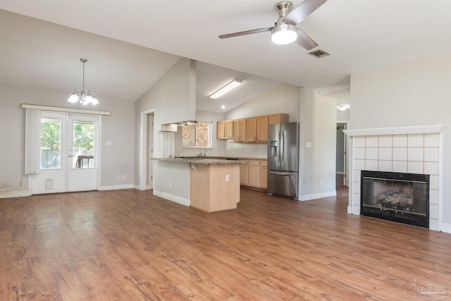 308 Twisted Oak Dr, Cantonment, FL 32533 - kitchen featuring visible vents, stainless steel refrigerator with ice dispenser, open floor plan, vaulted ceiling, and ceiling fan with notable chandelier