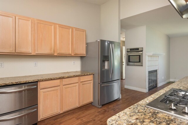 308 Twisted Oak Dr, Cantonment, FL 32533 - kitchen featuring a fireplace, dark wood-type flooring, wine cooler, appliances with stainless steel finishes, and light brown cabinetry