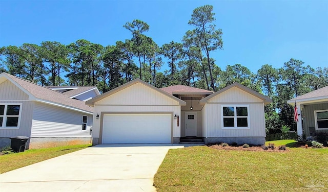 view of front of home featuring an attached garage, concrete driveway, and a front lawn