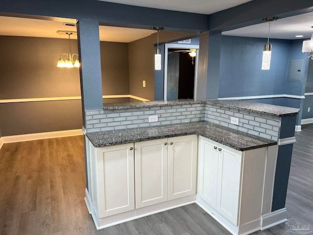 kitchen featuring dark wood-type flooring, white cabinetry, pendant lighting, and tasteful backsplash