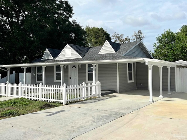 farmhouse featuring a porch and a carport