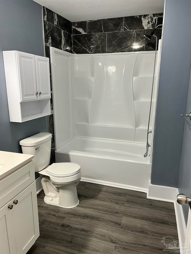 full bathroom with hardwood / wood-style flooring, vanity, toilet, and tiled shower / bath