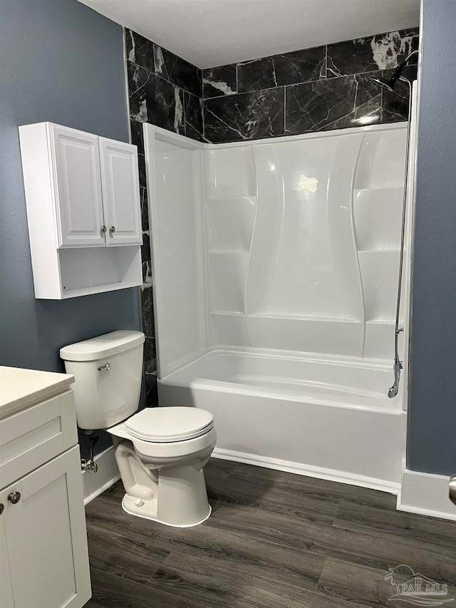 full bathroom featuring hardwood / wood-style floors, vanity, toilet, and tiled shower / bath combo