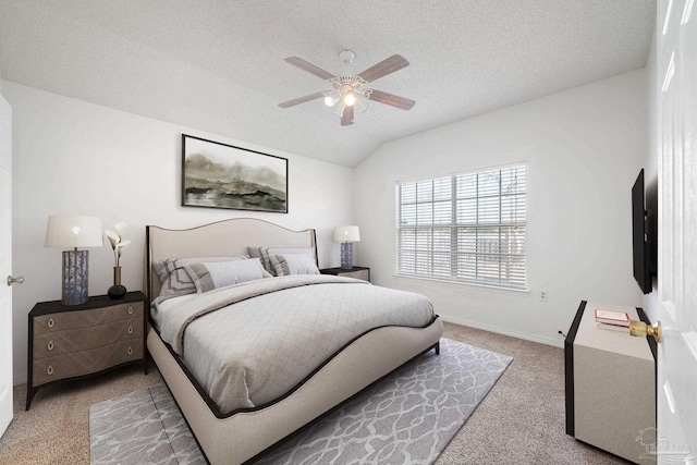 bedroom with lofted ceiling, carpet flooring, ceiling fan, a textured ceiling, and baseboards