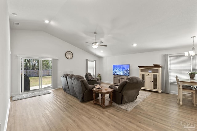 living room with light wood-type flooring, lofted ceiling, baseboards, and ceiling fan with notable chandelier