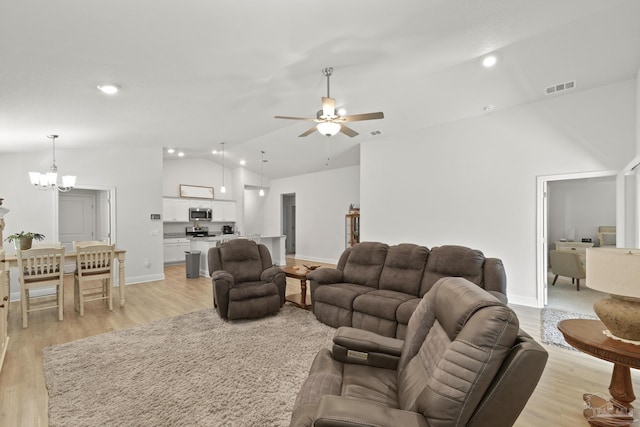 living room featuring visible vents, lofted ceiling, light wood-style flooring, ceiling fan with notable chandelier, and recessed lighting