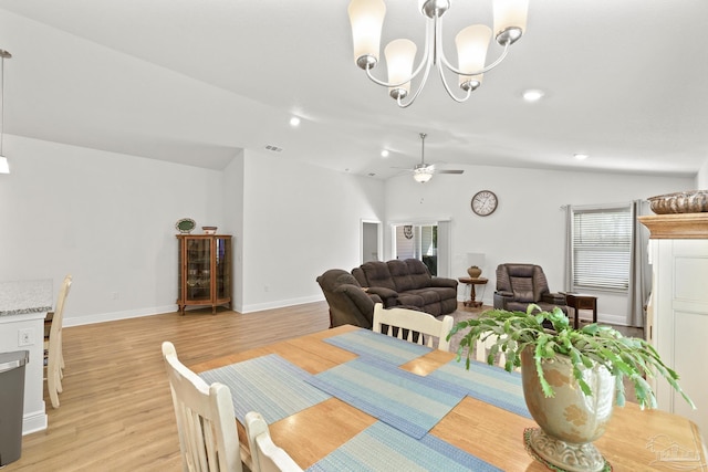 dining space with lofted ceiling, visible vents, and light wood finished floors