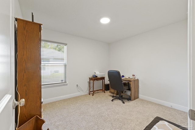 carpeted office space with baseboards