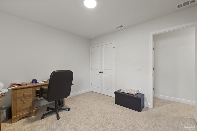 office featuring light colored carpet, visible vents, and baseboards