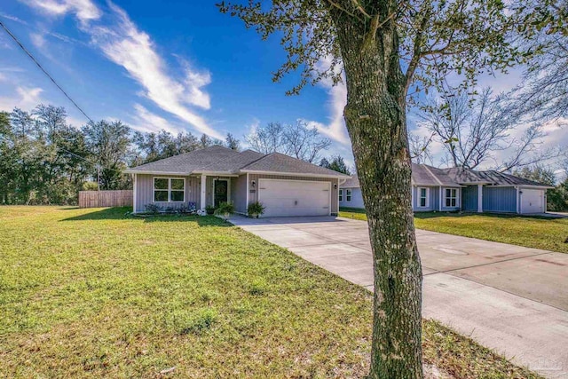 ranch-style home featuring concrete driveway, an attached garage, board and batten siding, fence, and a front lawn