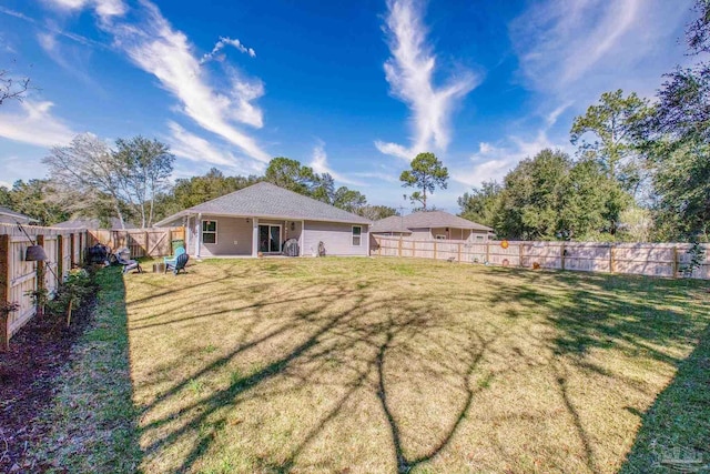 view of yard with a fenced backyard