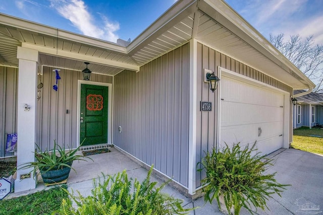 property entrance with a garage and driveway